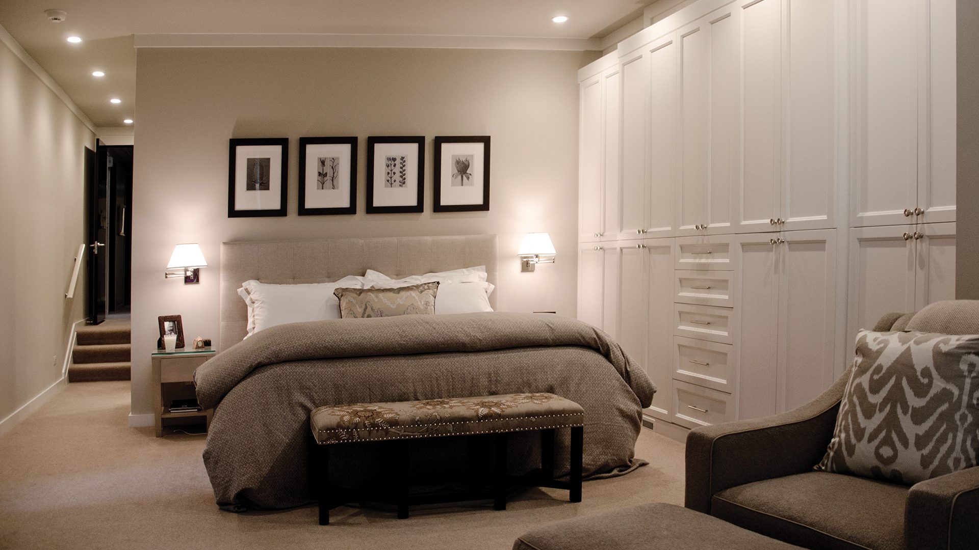 A bedroom with a bed, dresser and nightstand.