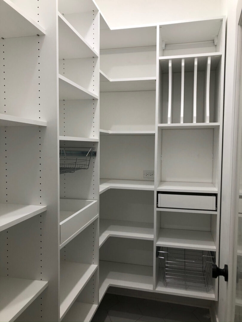 A pantry with many shelves and drawers in it