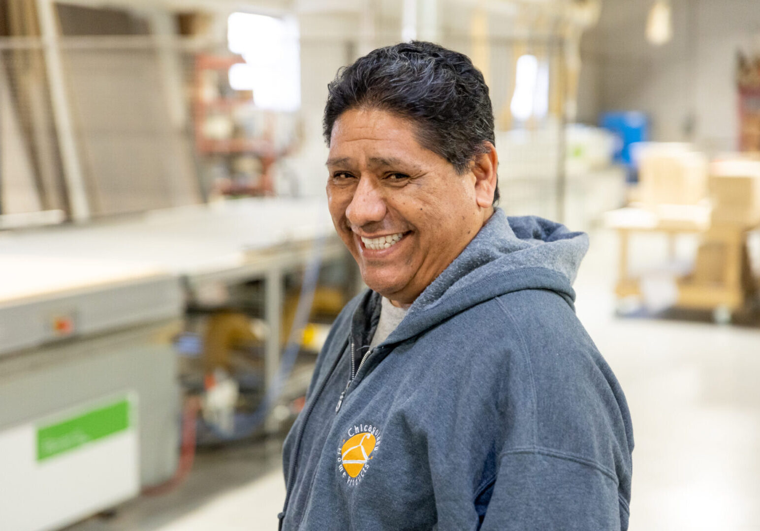 A man smiling for the camera in a kitchen.