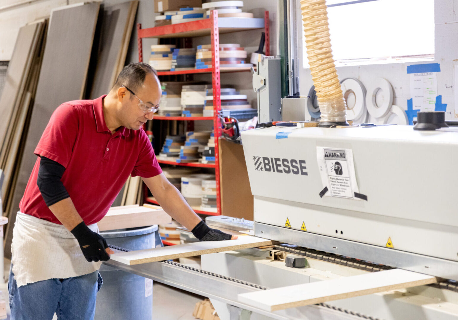 A man working in a shop with some kind of machine