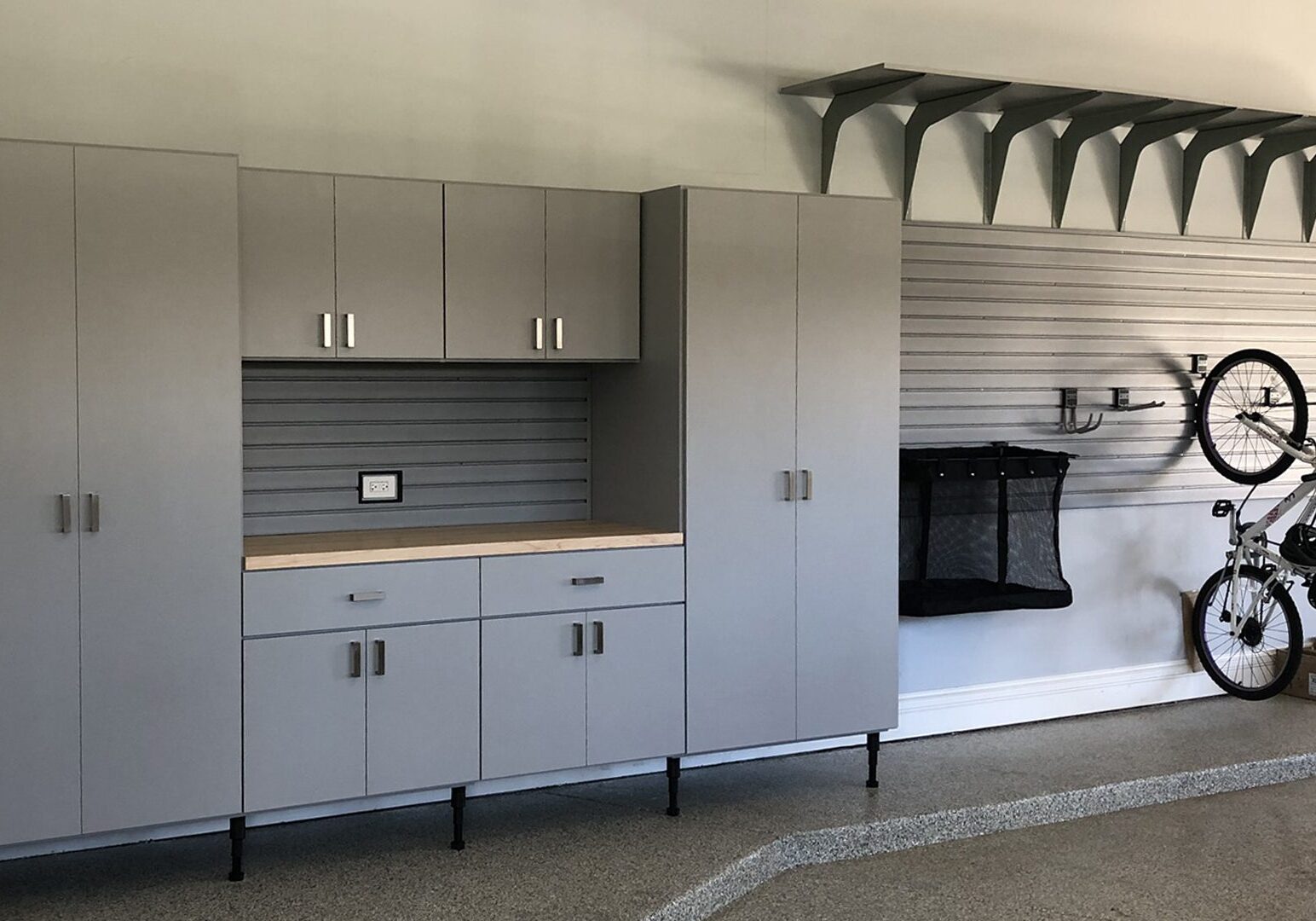 A garage with cabinets and a fireplace in it