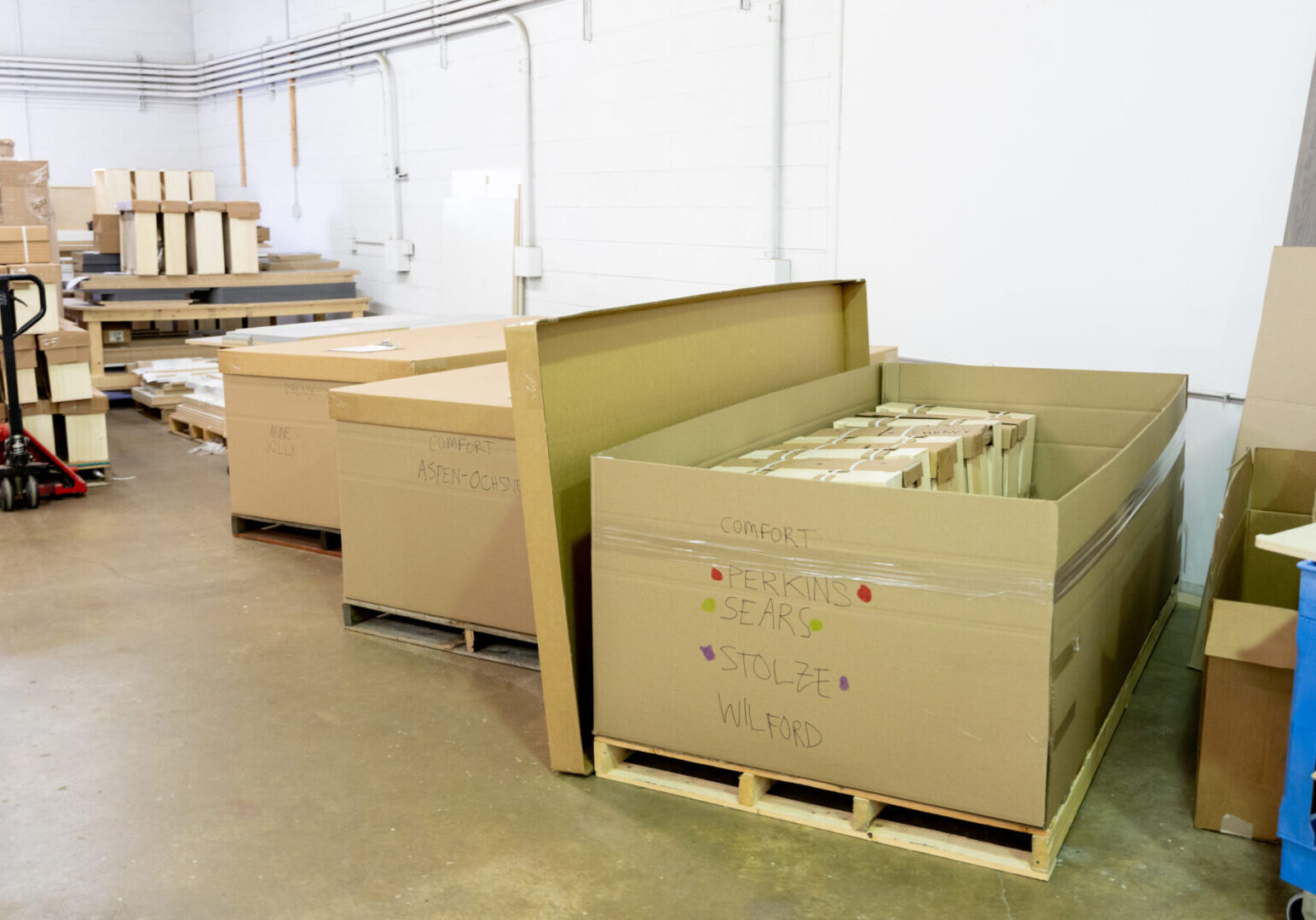 A warehouse with boxes and pallets of cardboard.