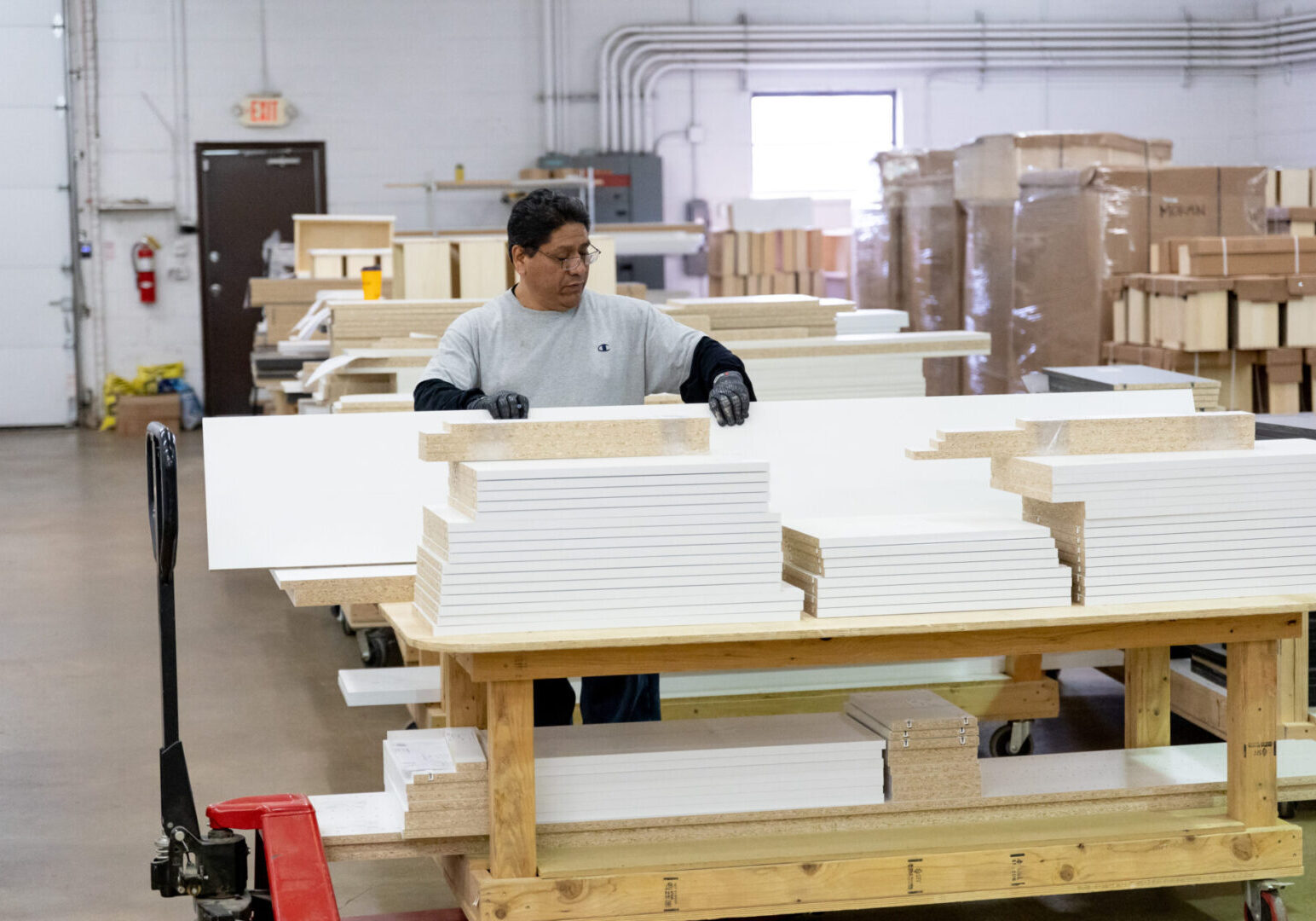 A person working in a factory with many boxes